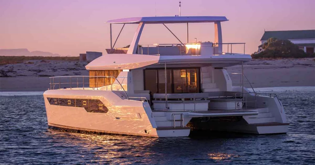 Catamaran sailing through crystal-clear Caribbean waters, offering spacious decks for relaxation.